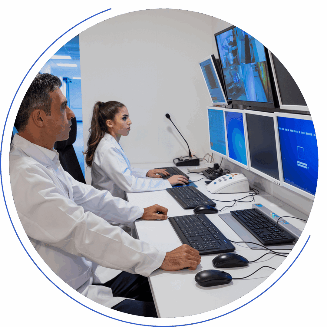 Scientists monitoring screens in a control room.